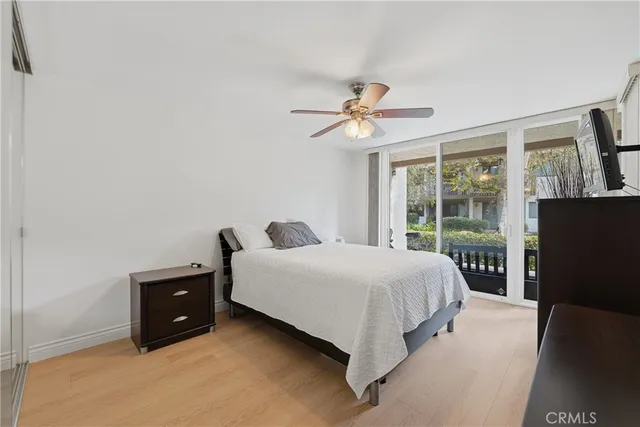 a bedroom with a bed and a television