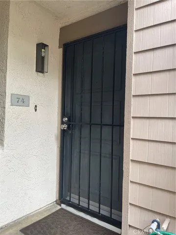 a swimming pool with outdoor space and trees in the background