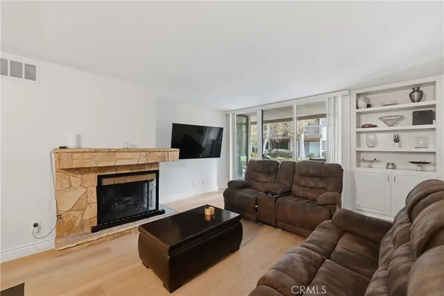 a living room with a fireplace and a wooden floor