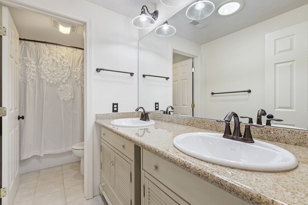 50 Sophia Drive Worcester, MA 01607 - Photo 20 of 37 a bathroom with a double vanity sink and a mirror