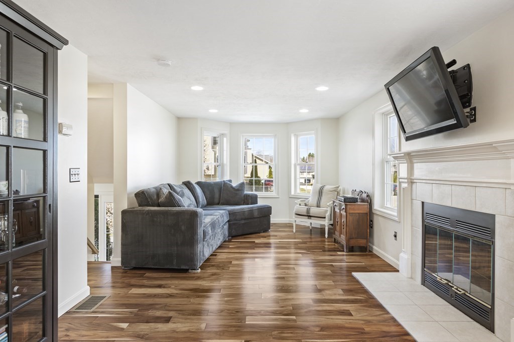 50 Sophia Drive Worcester, MA 01607 - Photo 3 of 37 a living room with furniture a fireplace and a flat screen tv