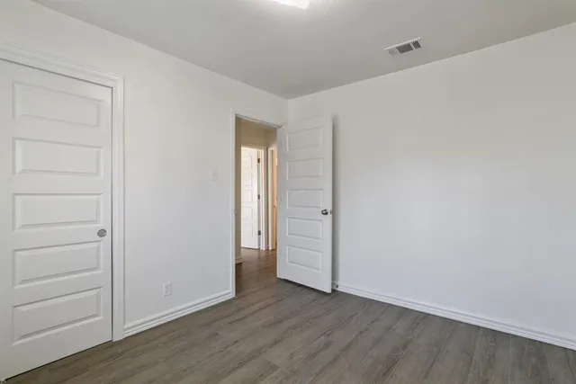 a view of an empty room and wooden floor