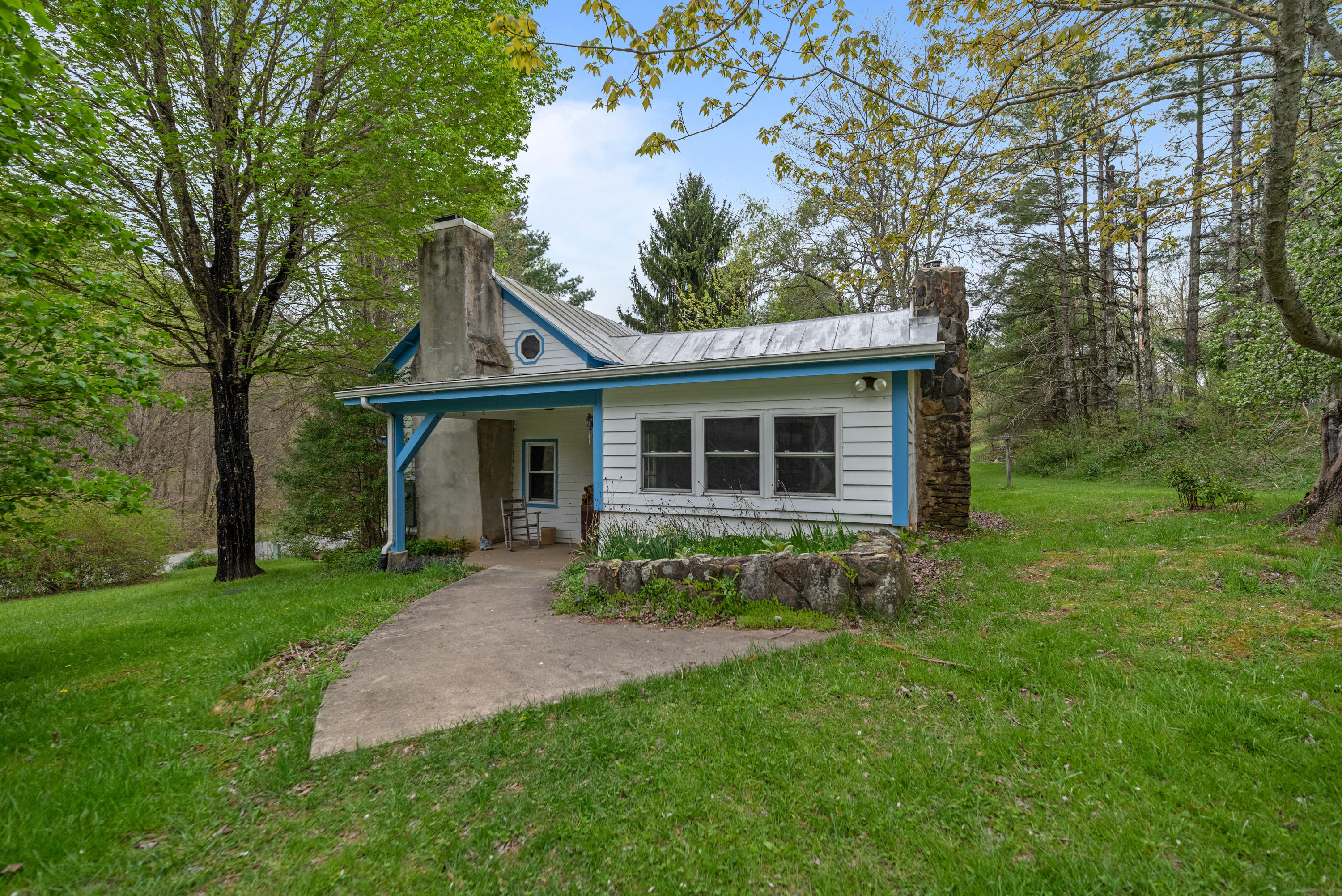 757 Halls Store Road Southwest Willis, VA 24380 - Photo 2 of 43 a front view of a house with a garden