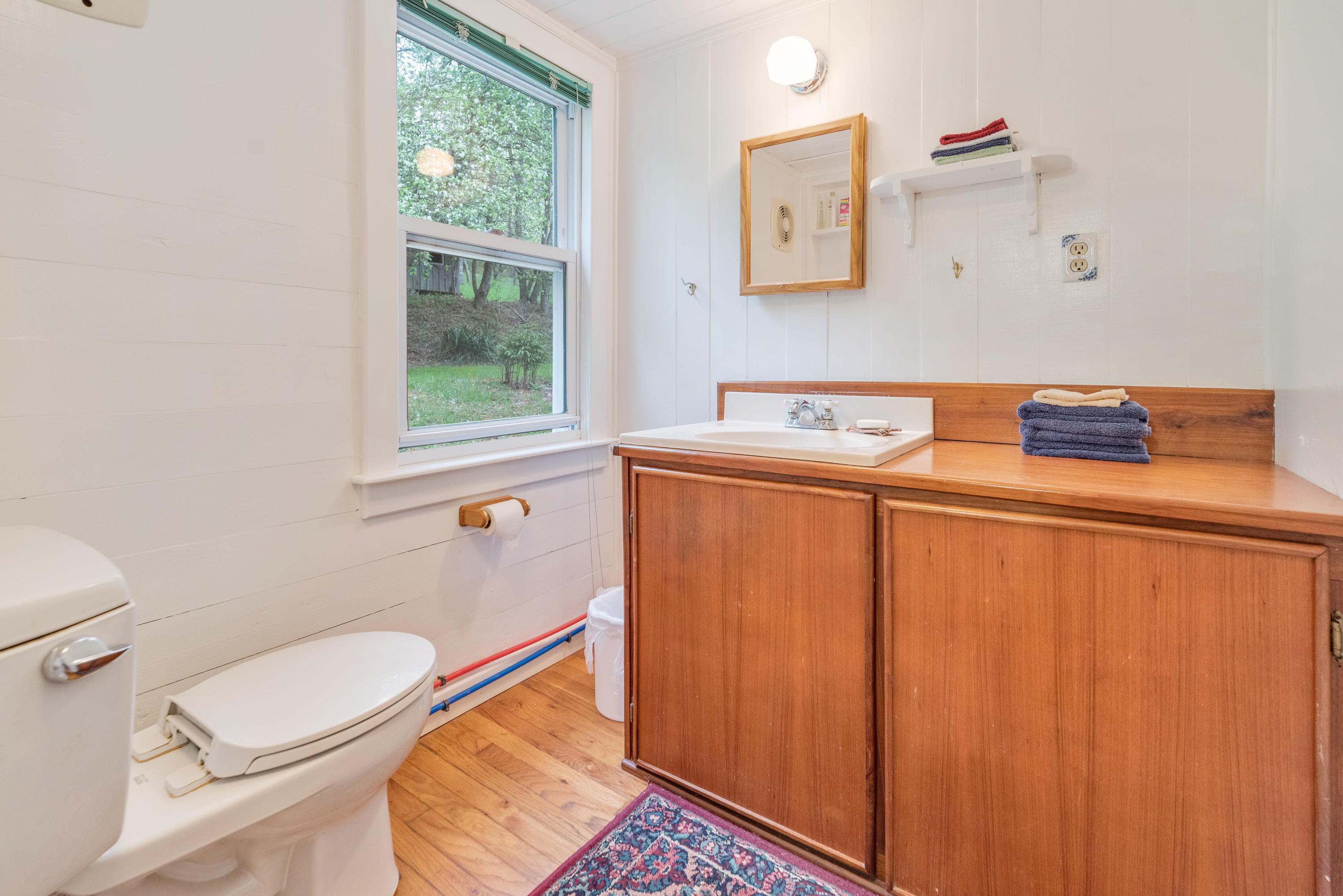 757 Halls Store Road Southwest Willis, VA 24380 - Photo 14 of 43 a bathroom with a sink toilet and a window