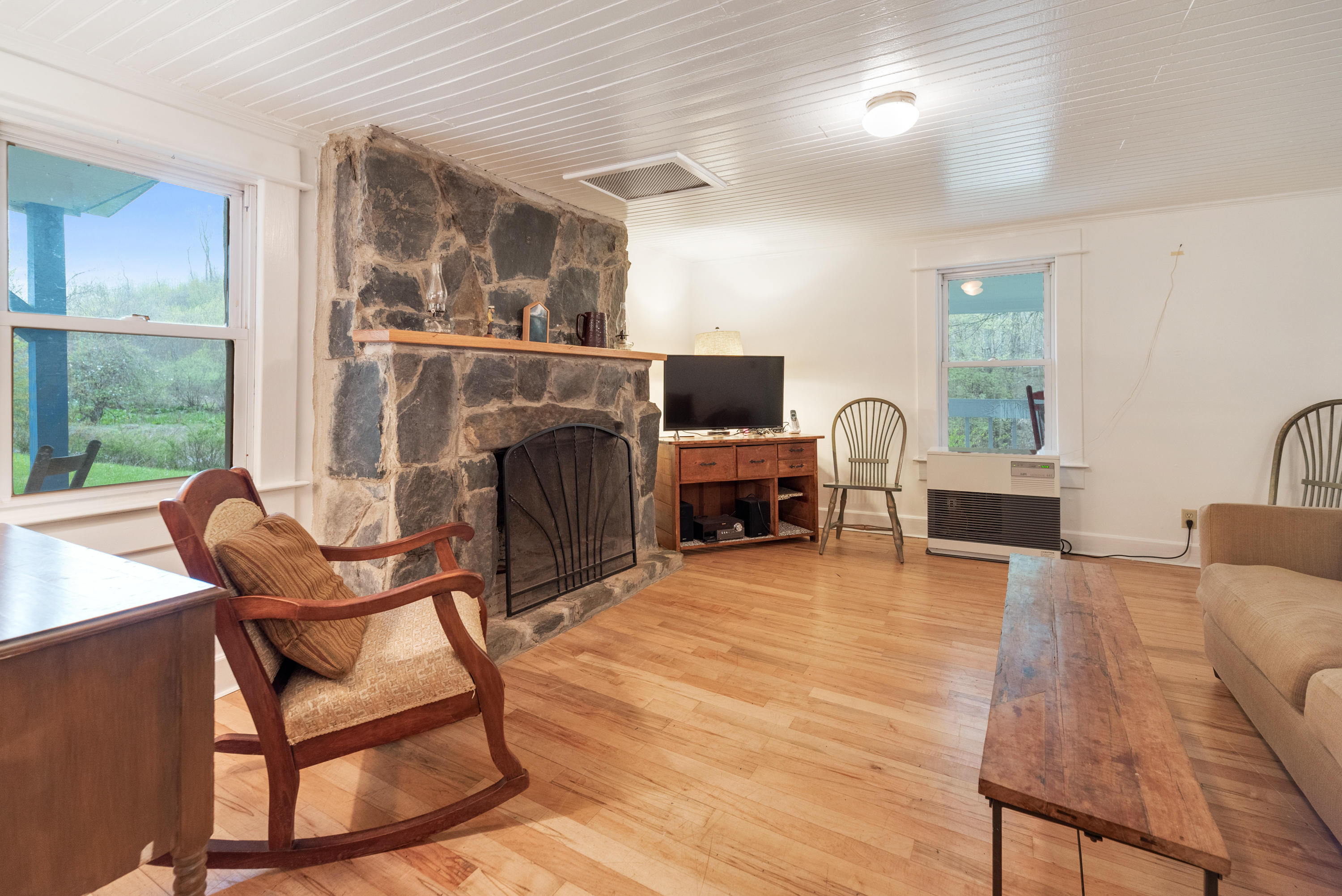 757 Halls Store Road Southwest Willis, VA 24380 - Photo 15 of 43 a living room with furniture a fireplace and a large window