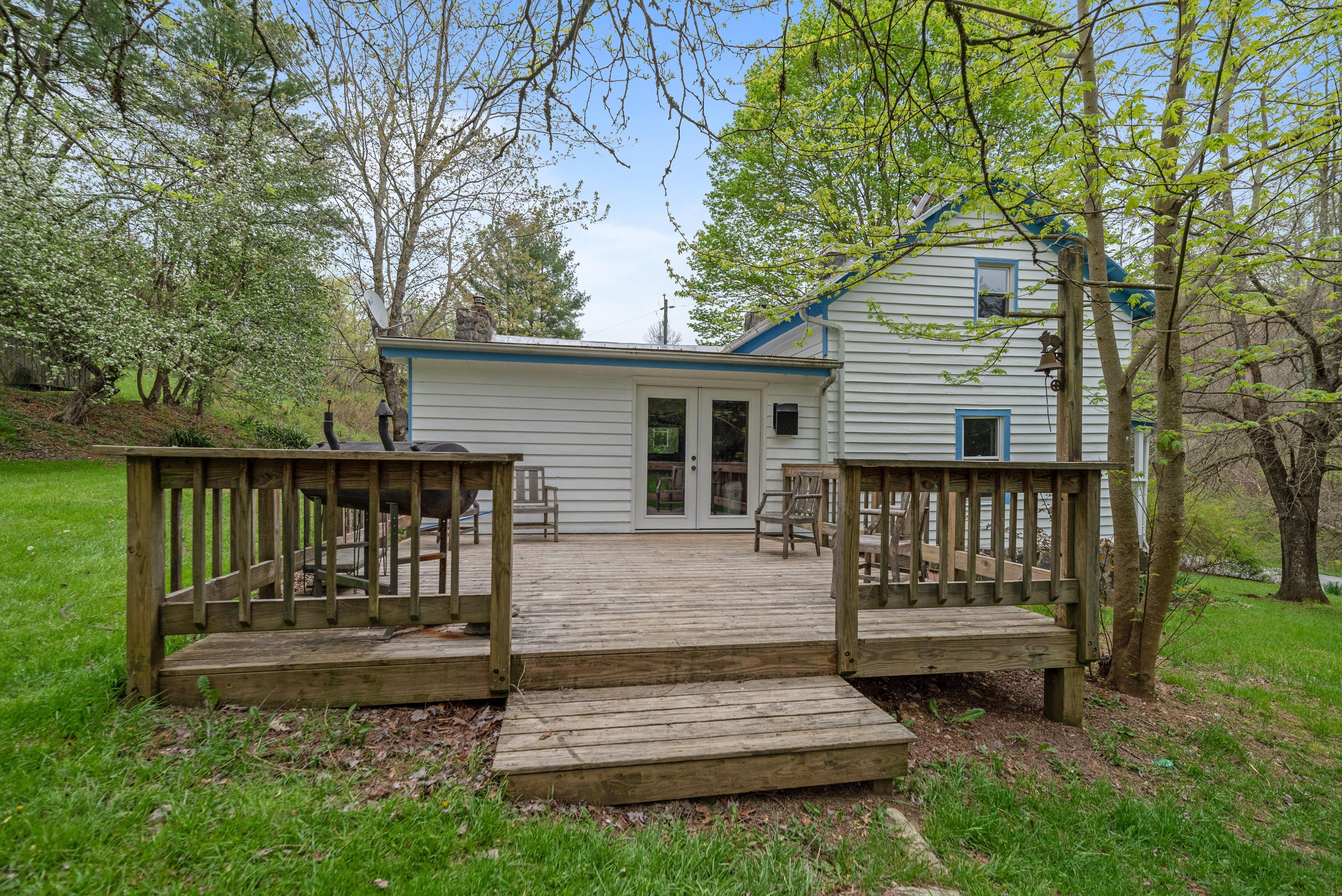 757 Halls Store Road Southwest Willis, VA 24380 - Photo 25 of 43 a view of a wooden bench and chair in the yard