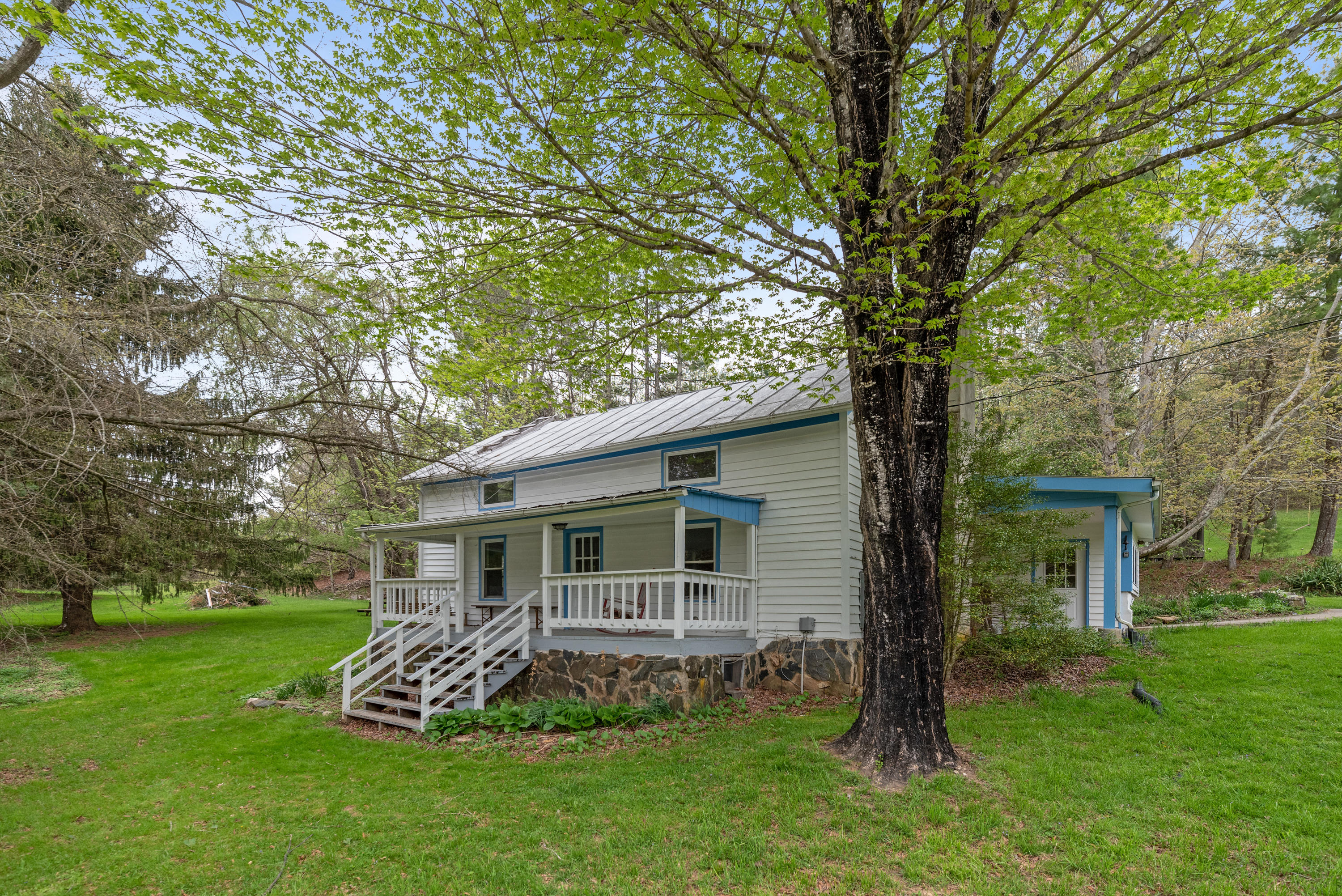 757 Halls Store Road Southwest Willis, VA 24380 - Photo 30 of 43 a view of a backyard with table and chairs and a large tree