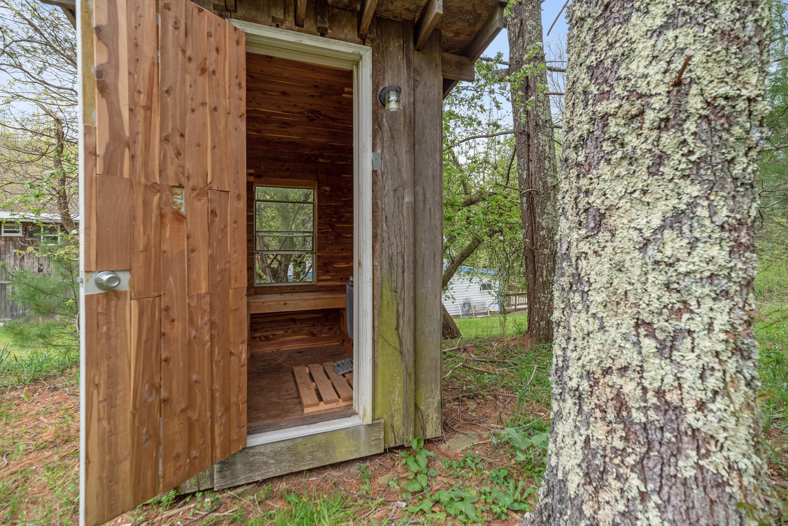 757 Halls Store Road Southwest Willis, VA 24380 - Photo 34 of 43 a view of a glass door with a tree