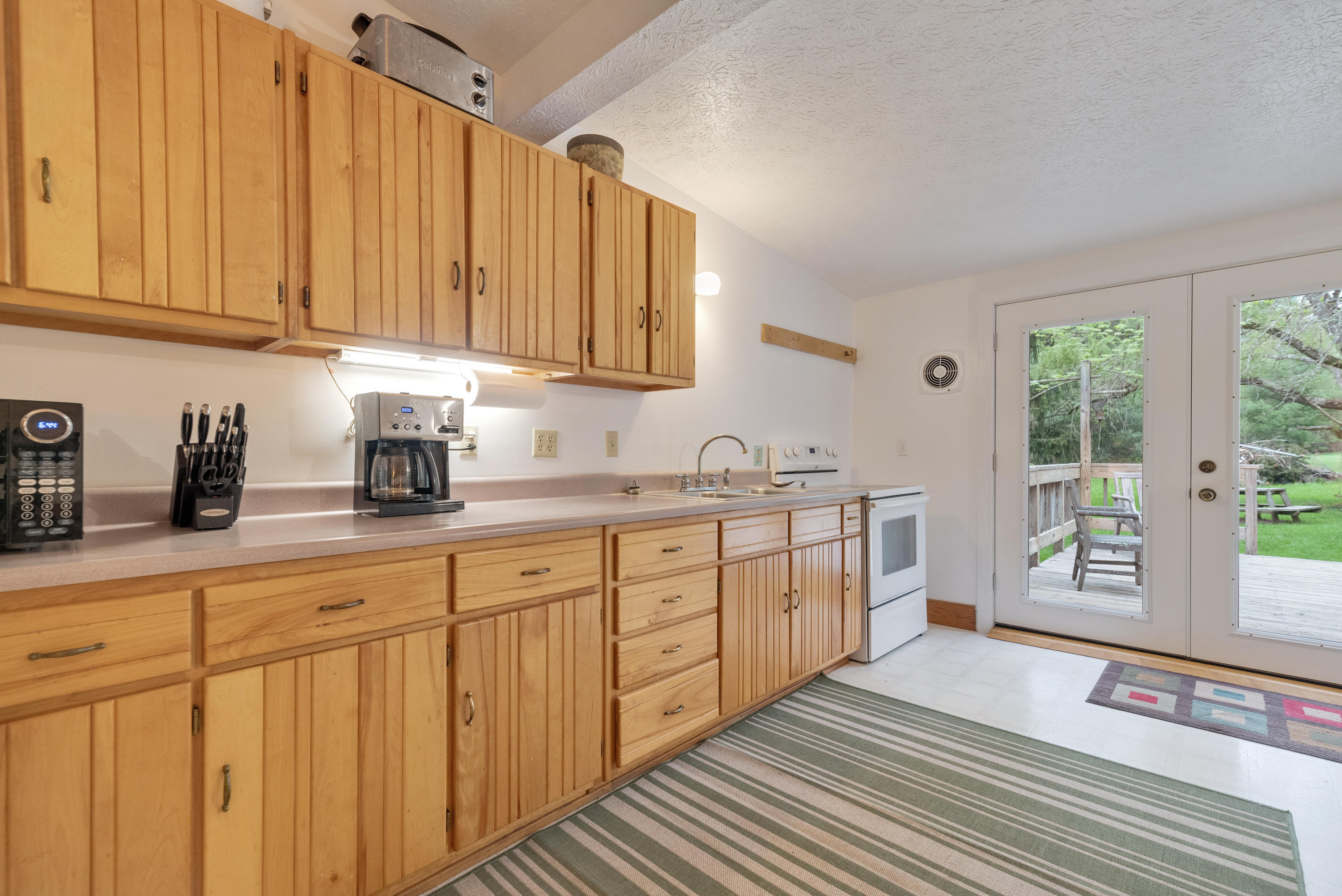 757 Halls Store Road Southwest Willis, VA 24380 - Photo 10 of 43 a spacious bathroom with stainless steel appliances a sink cabinets and a window