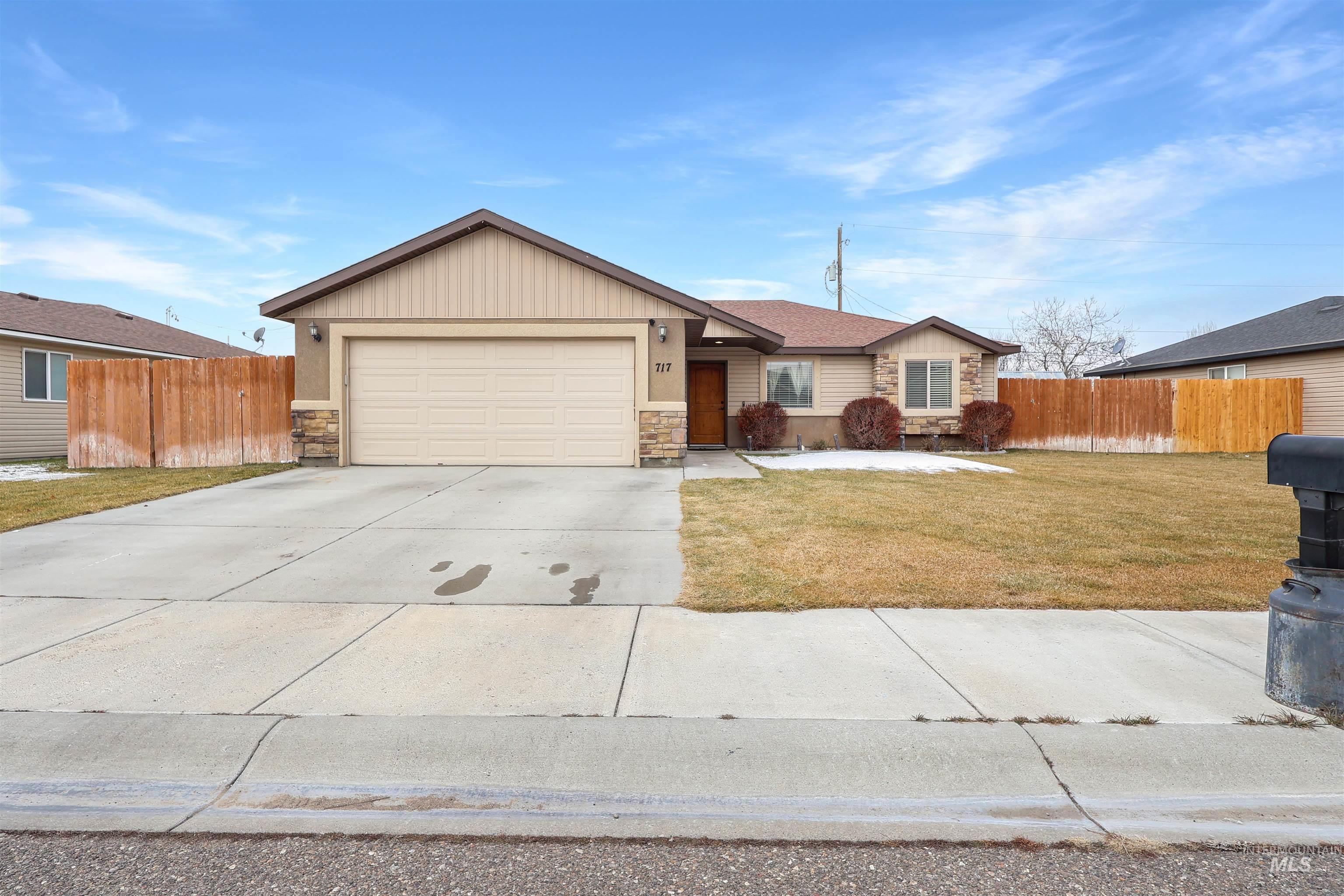 Ranch-style home with stone siding, concrete driveway, and a garage