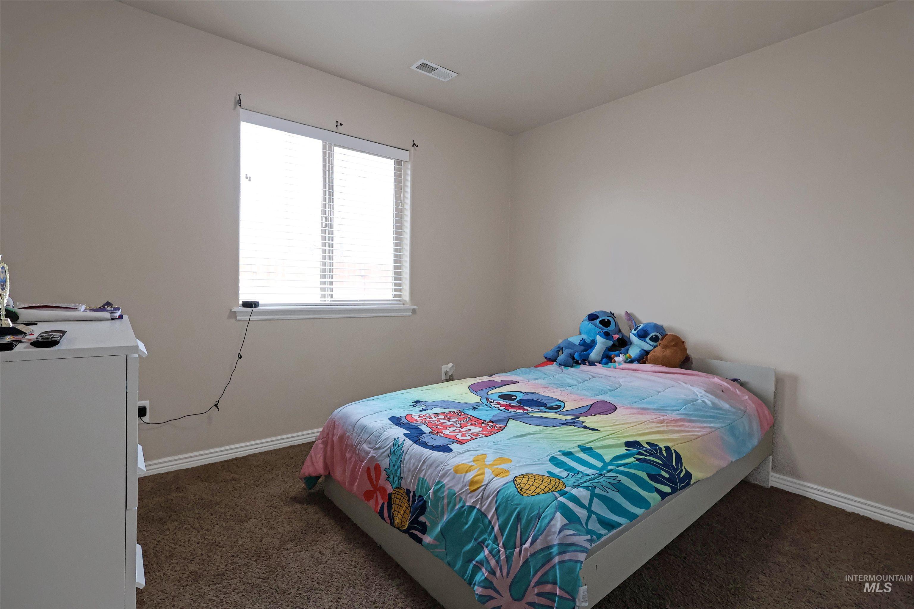 717 South B Street Rupert, ID 83350 - Photo 11 of 13 Bedroom featuring dark colored carpet and baseboards