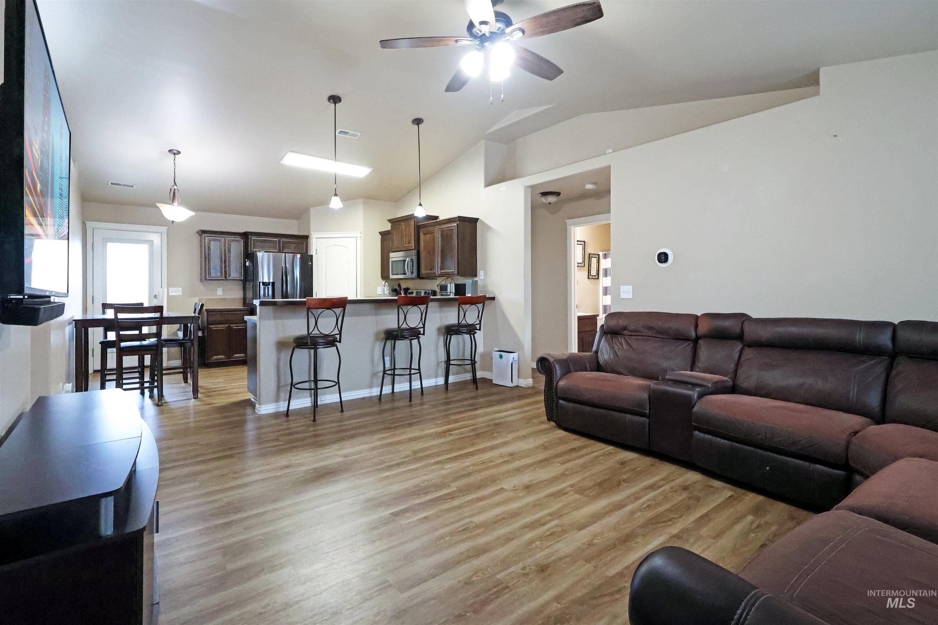 717 South B Street Rupert, ID 83350 - Photo 4 of 13 Living room featuring light wood-type flooring, ceiling fan, and high vaulted ceiling