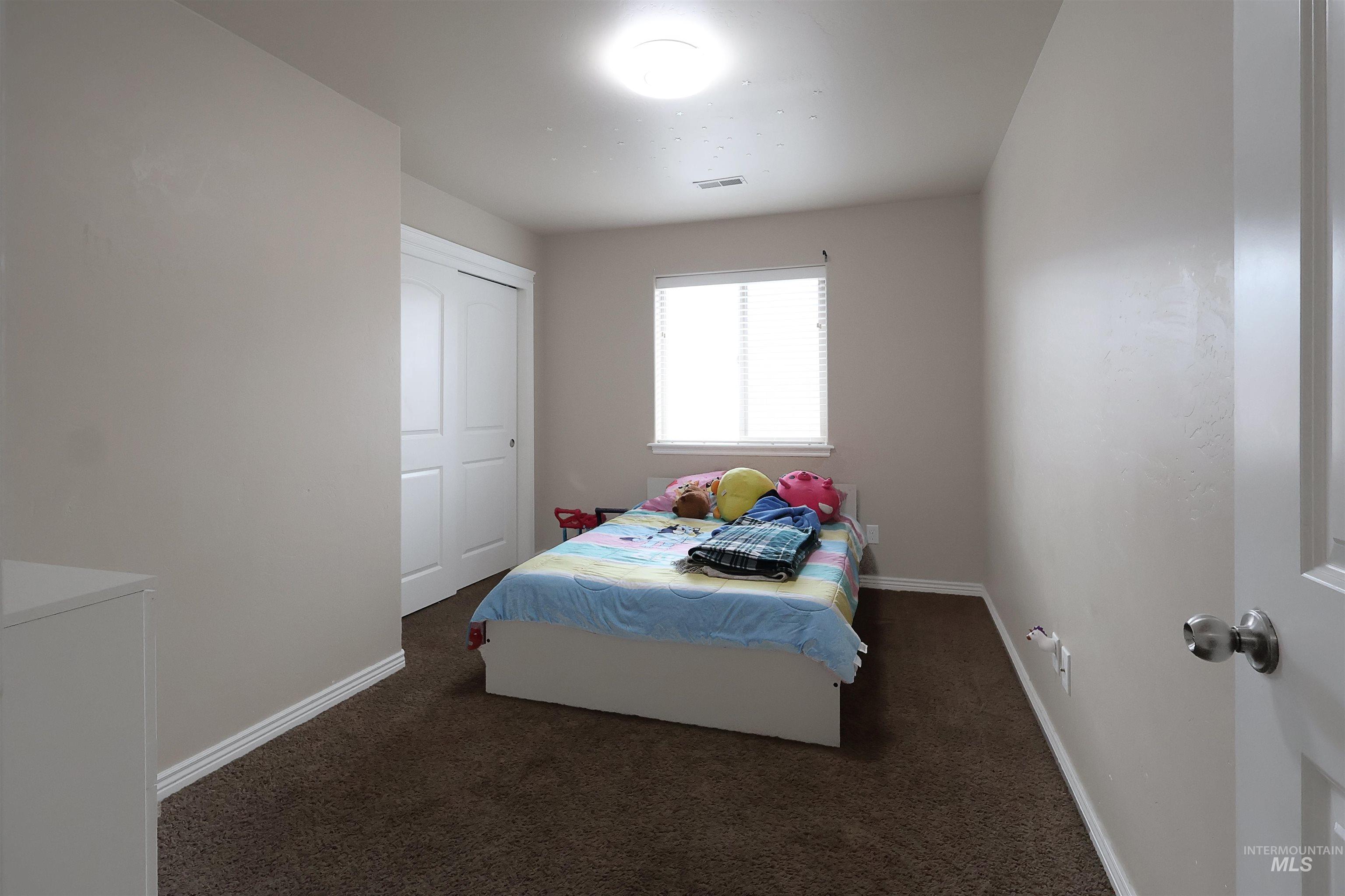 717 South B Street Rupert, ID 83350 - Photo 8 of 13 Bedroom featuring baseboards and dark colored carpet