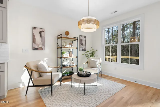a view of a livingroom with furniture window and wooden floor