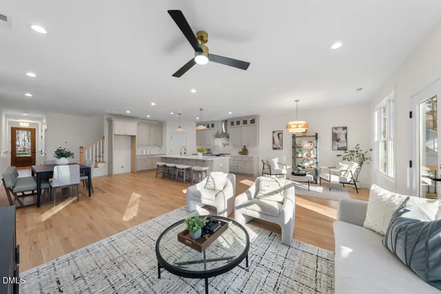 a living room with furniture and kitchen view