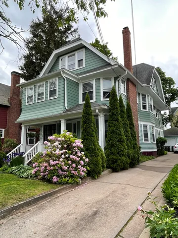 a front view of a house with a garden