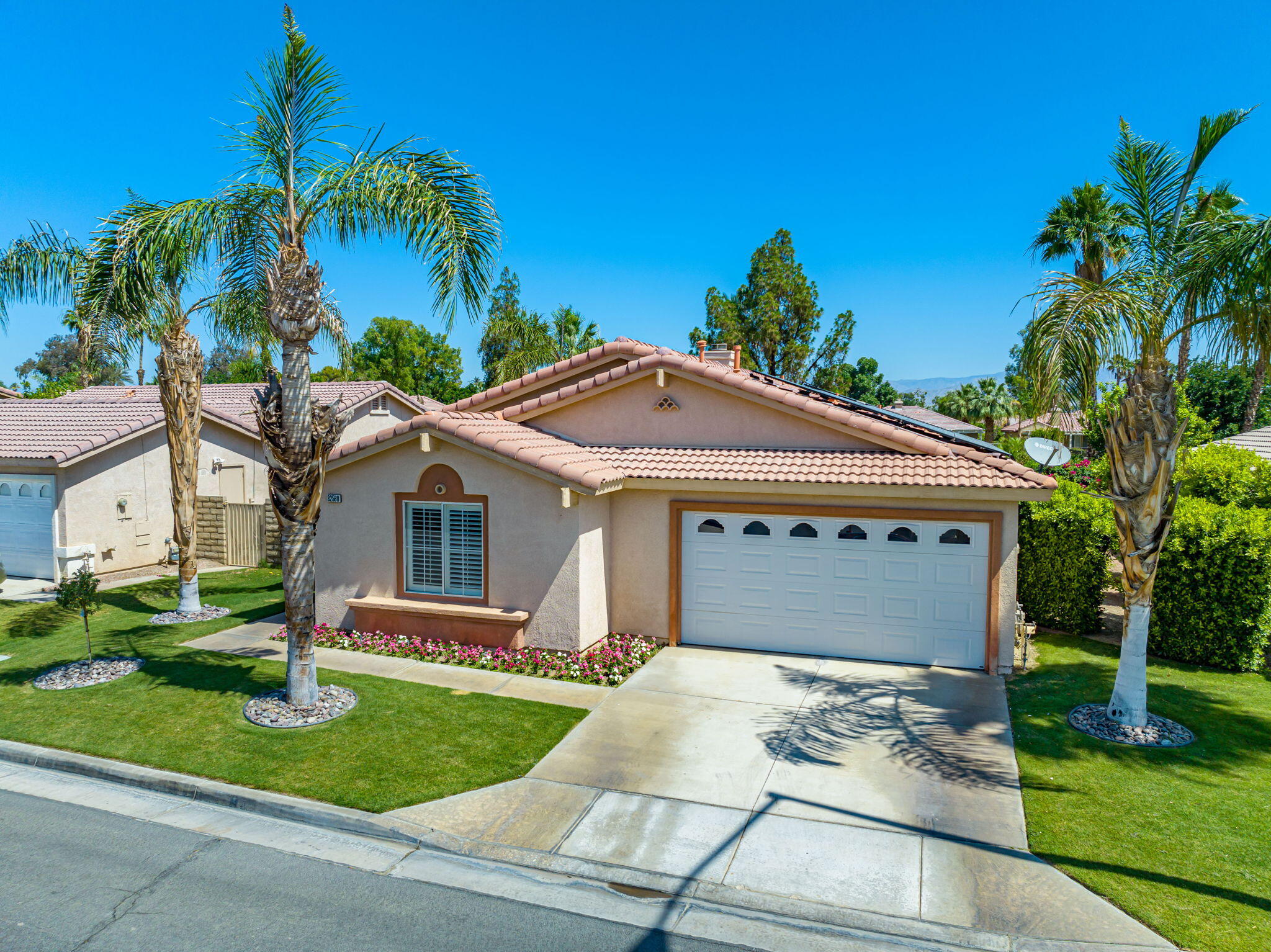 82560 Delano Drive Indio, CA 92201 - Photo 1 of 51 a front view of a house with a yard and garage
