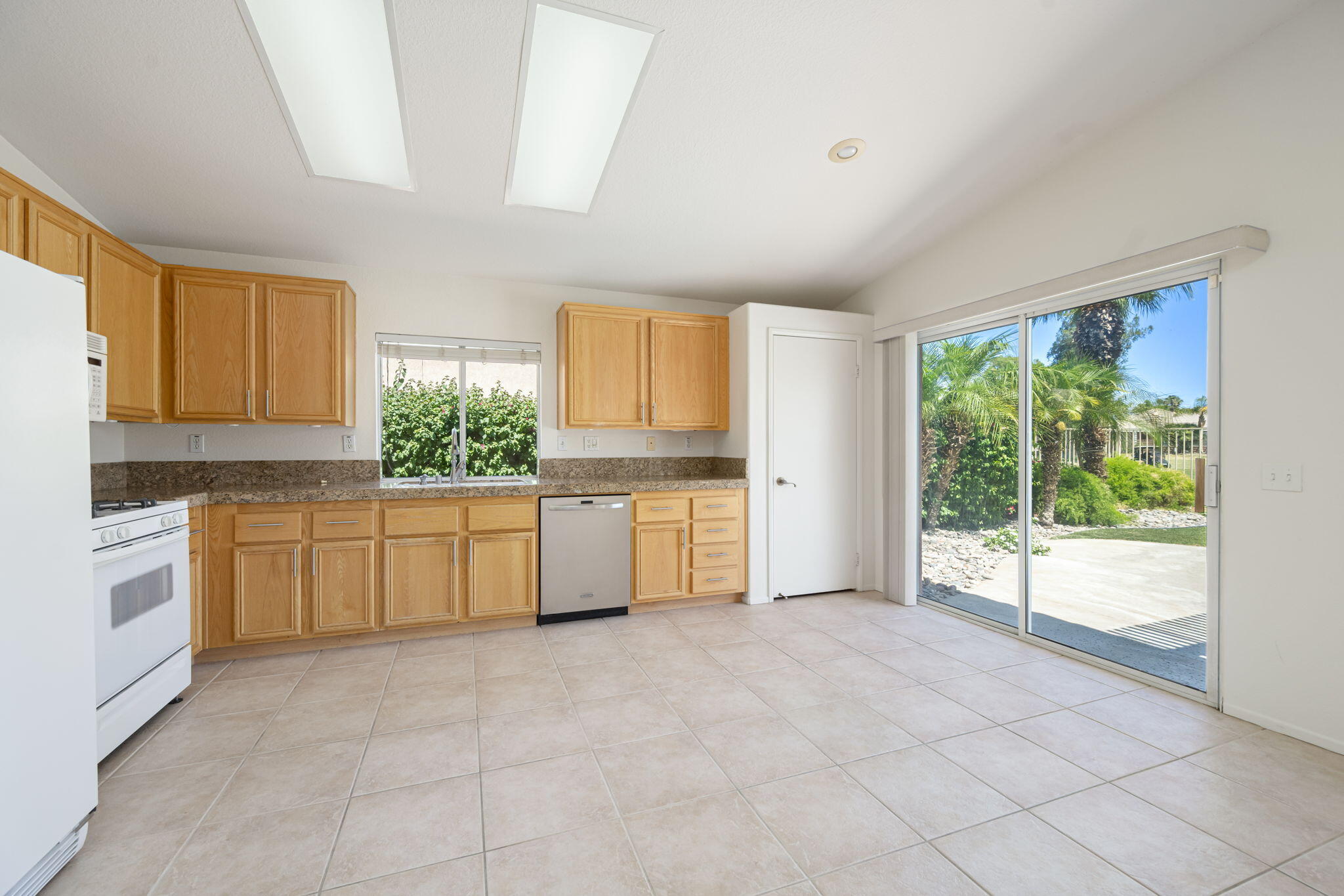 82560 Delano Drive Indio, CA 92201 - Photo 11 of 51 a large kitchen with a large window appliances and cabinets