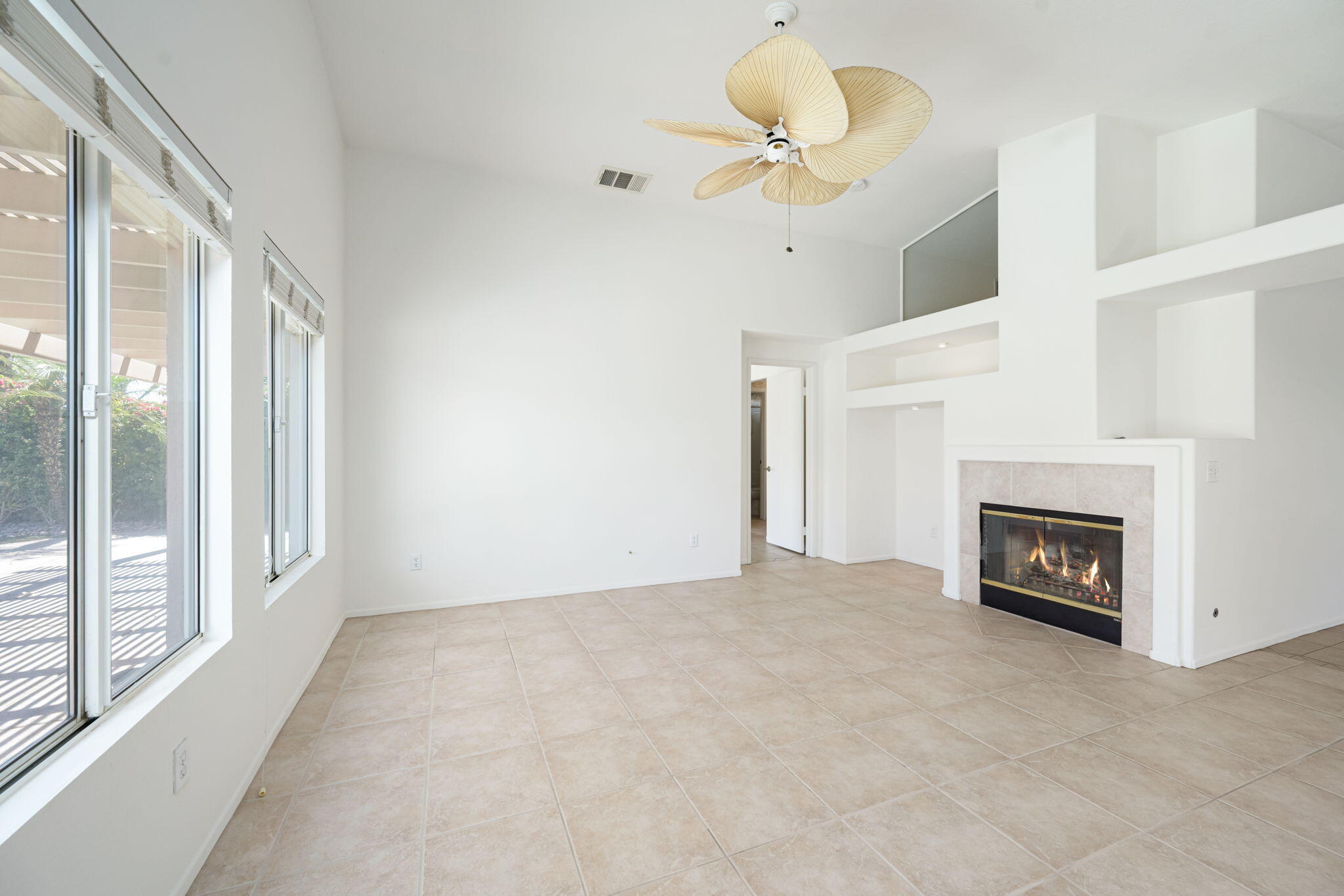 82560 Delano Drive Indio, CA 92201 - Photo 14 of 51 a view of a livingroom with a fireplace and a chandelier
