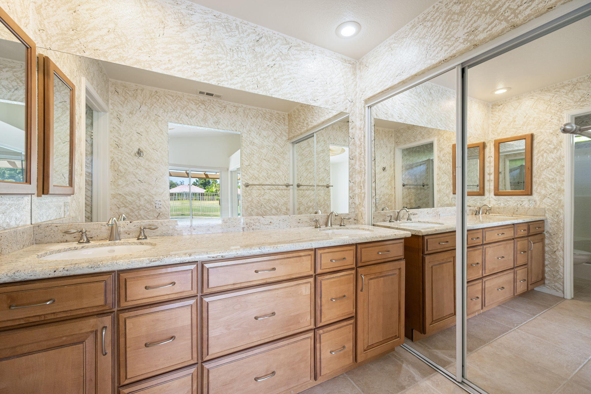 82560 Delano Drive Indio, CA 92201 - Photo 17 of 51 a spacious bathroom with a granite countertop sink mirror and double