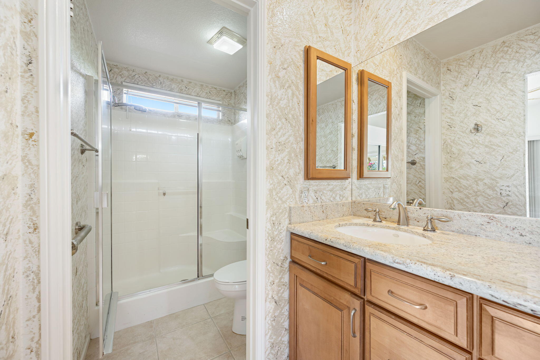 82560 Delano Drive Indio, CA 92201 - Photo 18 of 51 a bathroom with a shower sink vanity and mirror