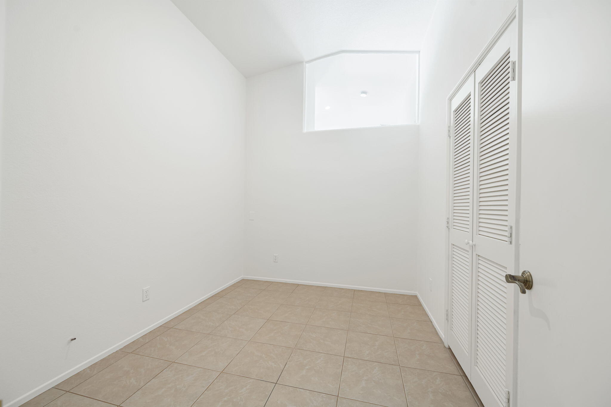 82560 Delano Drive Indio, CA 92201 - Photo 19 of 51 a view of a room with a white wall and a window