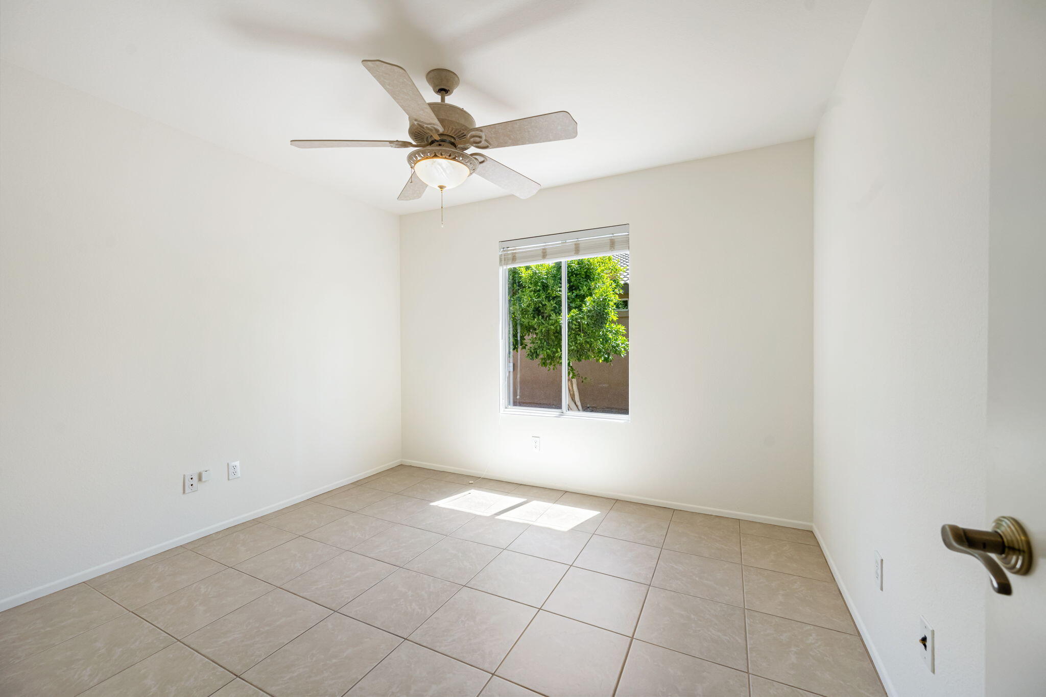 82560 Delano Drive Indio, CA 92201 - Photo 20 of 51 an empty room with windows and fan