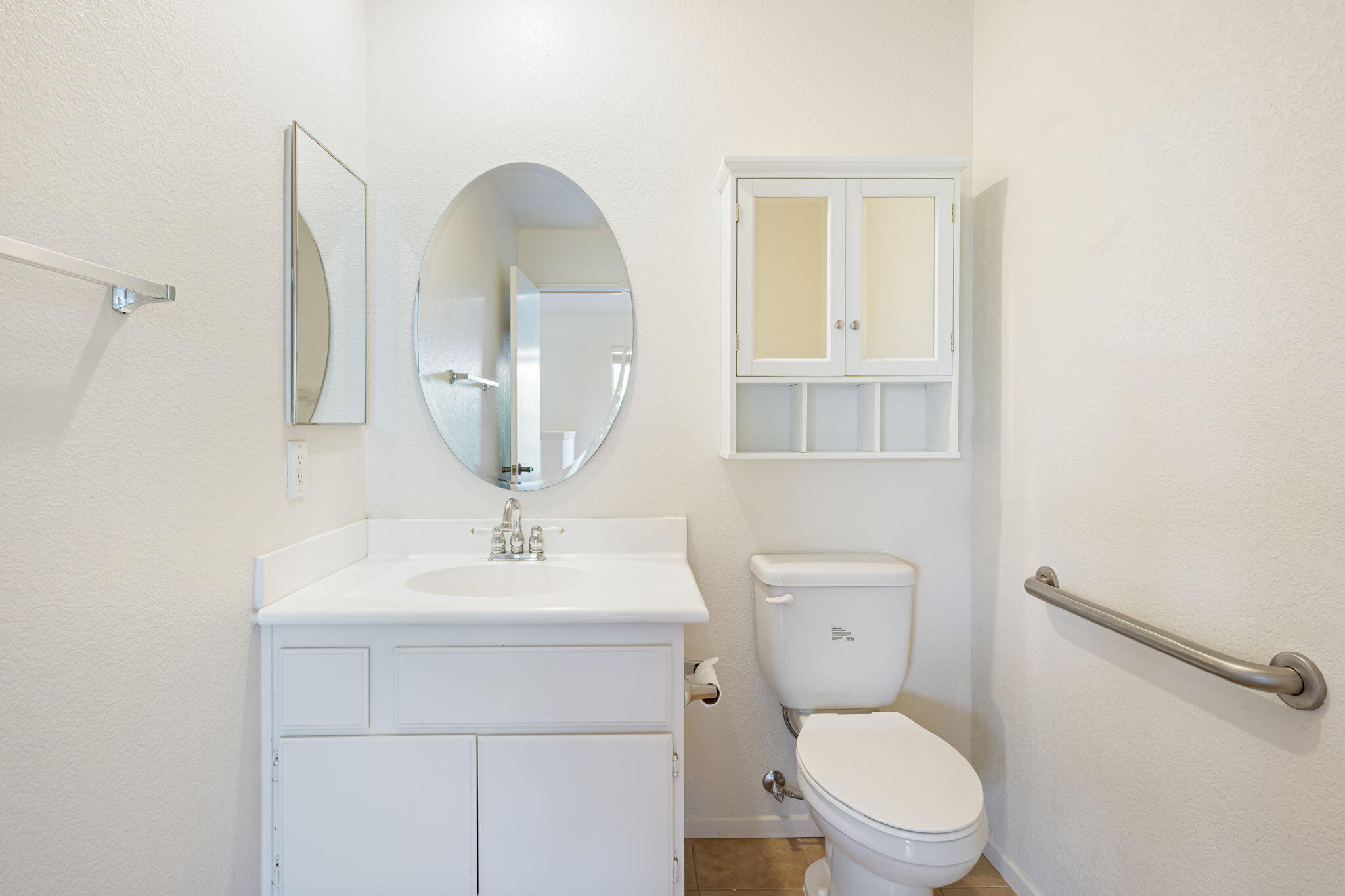 82560 Delano Drive Indio, CA 92201 - Photo 21 of 51 a bathroom with a toilet sink and mirror