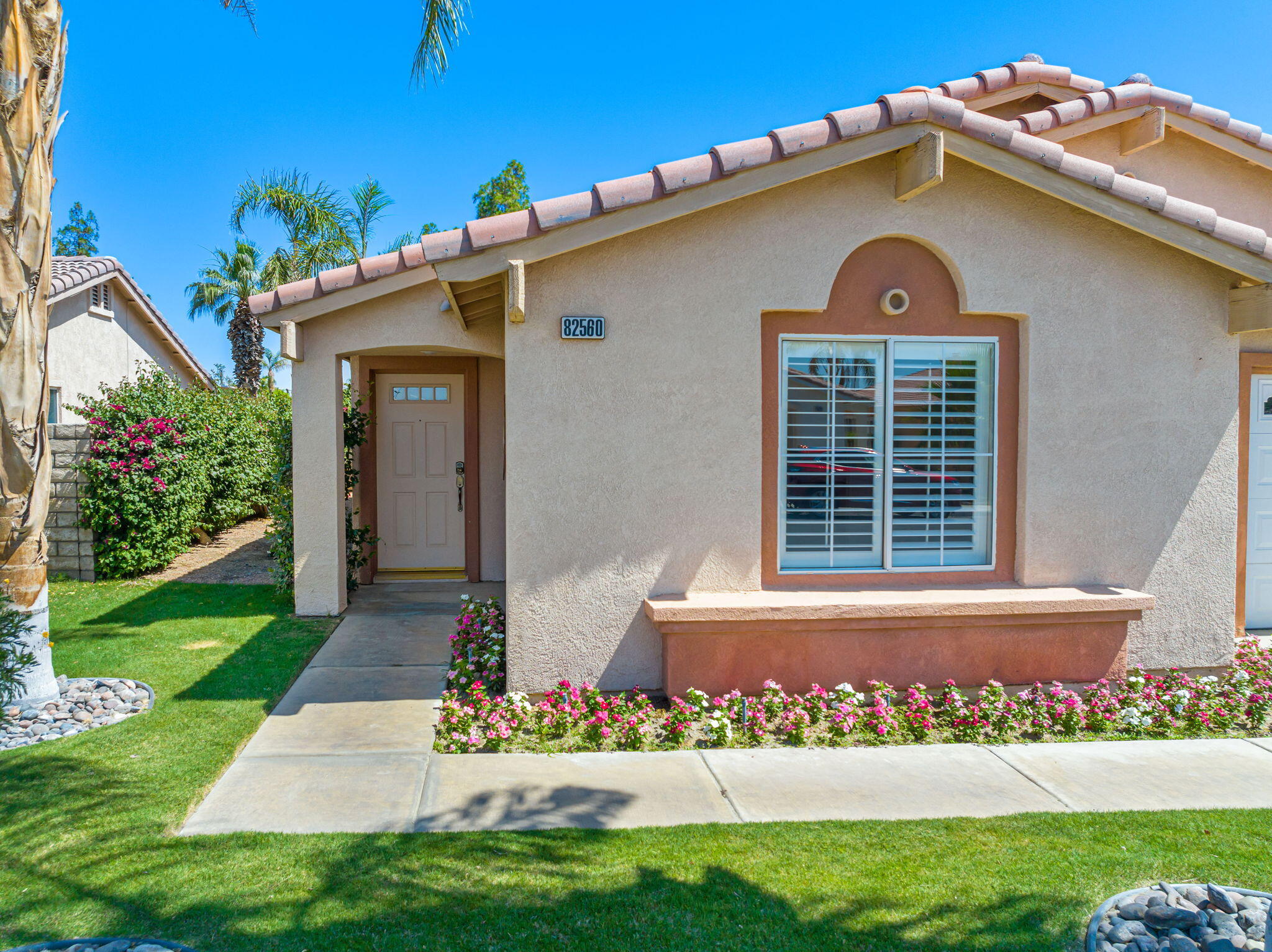 82560 Delano Drive Indio, CA 92201 - Photo 3 of 51 front view of a house with a yard