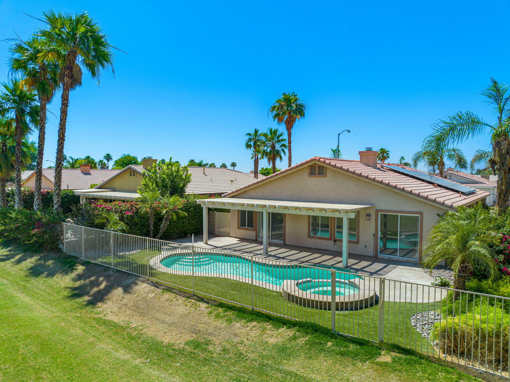 82560 Delano Drive Indio, CA 92201 - Photo 39 of 51 a front view of a house with a yard table and chairs