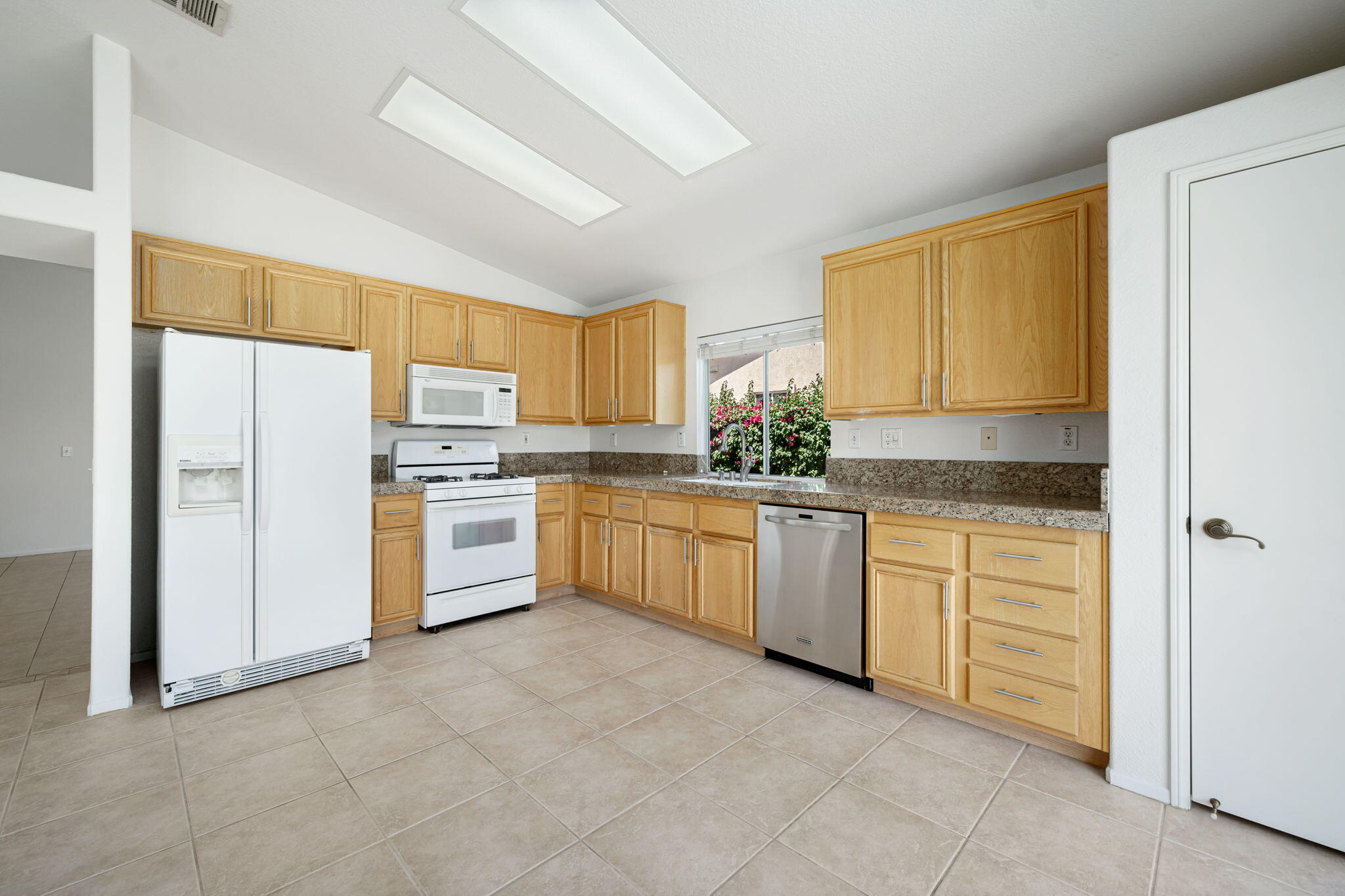 82560 Delano Drive Indio, CA 92201 - Photo 10 of 51 a kitchen with white cabinets and white appliances
