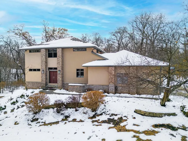a view of a house with a yard covered in snow