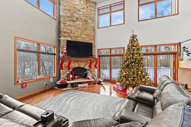 a living room with furniture a flat screen tv and a fireplace