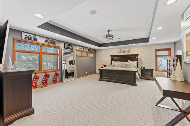 a bedroom with a bed and a chandelier