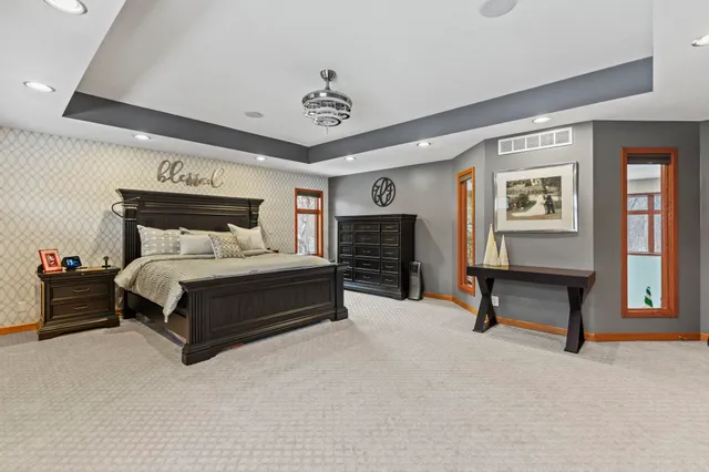 a spacious bedroom with a bed and a television in it