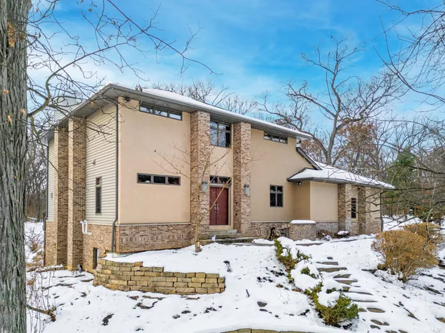 a view of a house with a snow on the road
