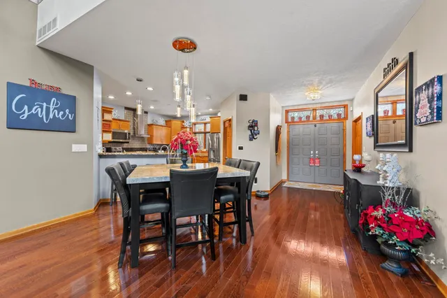 a view of a dining room with furniture and wooden floor