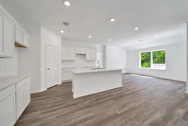 a view of kitchen with wooden floor and electronic appliances