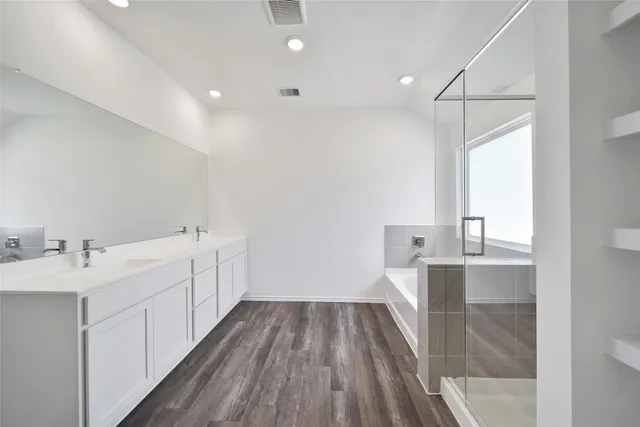 a view of a kitchen with a sink and wooden floor