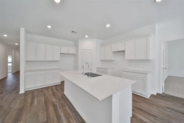 a kitchen with a sink a stove and cabinets