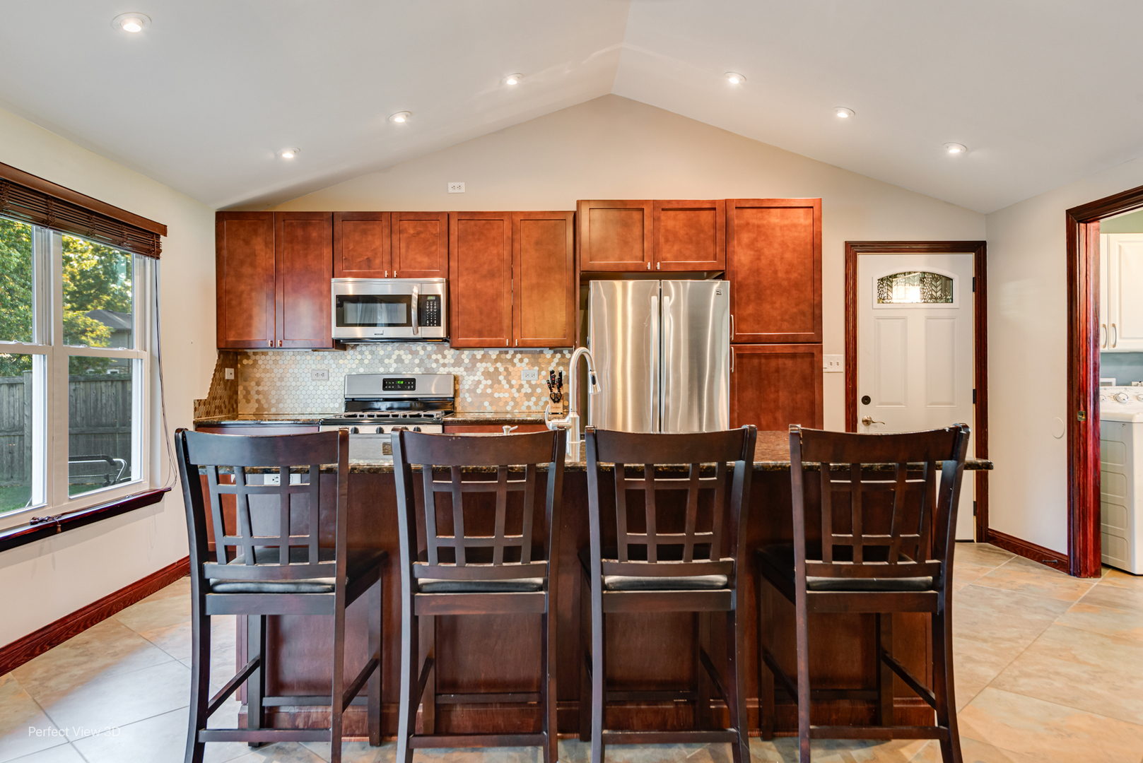 800 Charles Street Morris, IL 60450 - Photo 12 of 24 a kitchen with stainless steel appliances a table chairs and a refrigerator