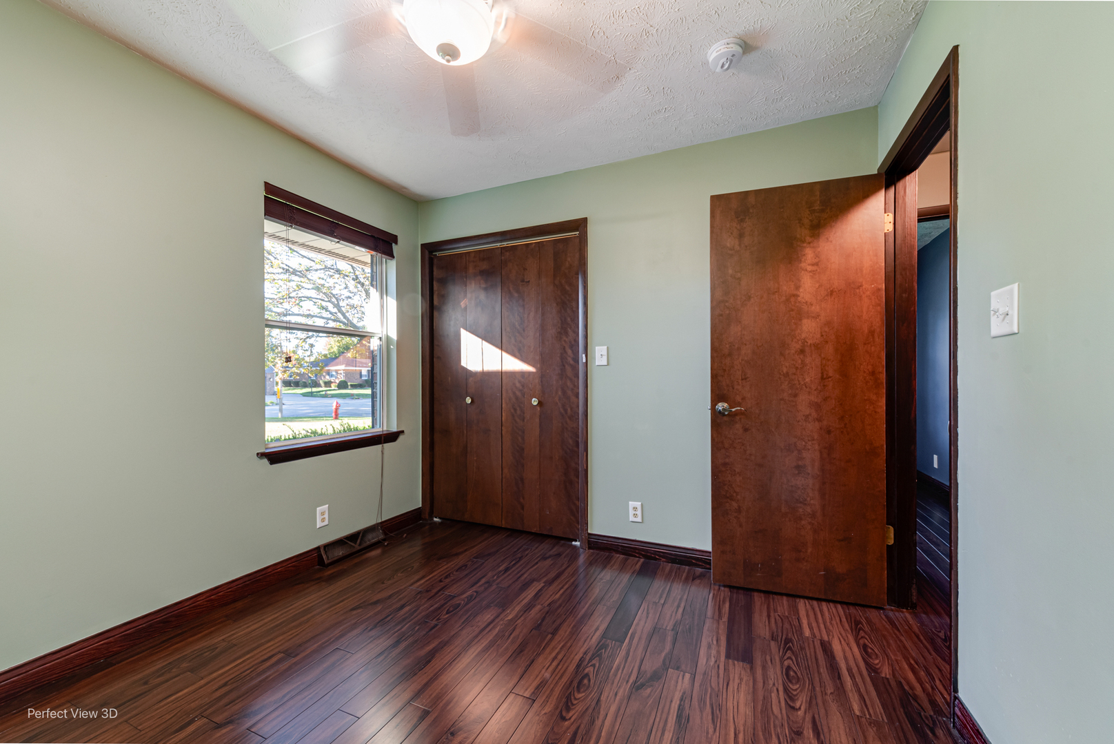 800 Charles Street Morris, IL 60450 - Photo 14 of 24 an empty room with wooden floor and windows