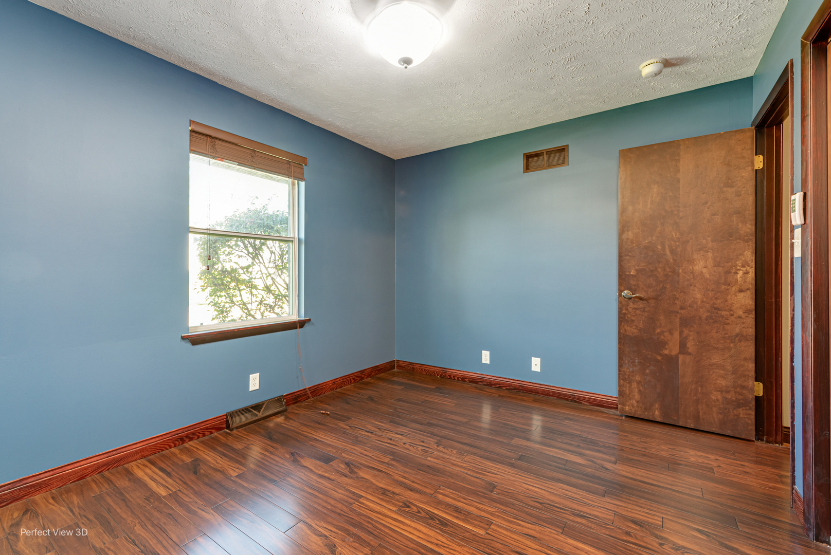 800 Charles Street Morris, IL 60450 - Photo 17 of 24 an empty room with wooden floor and windows