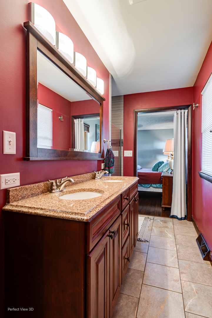 800 Charles Street Morris, IL 60450 - Photo 21 of 24 a bathroom with a granite countertop sink and a mirror