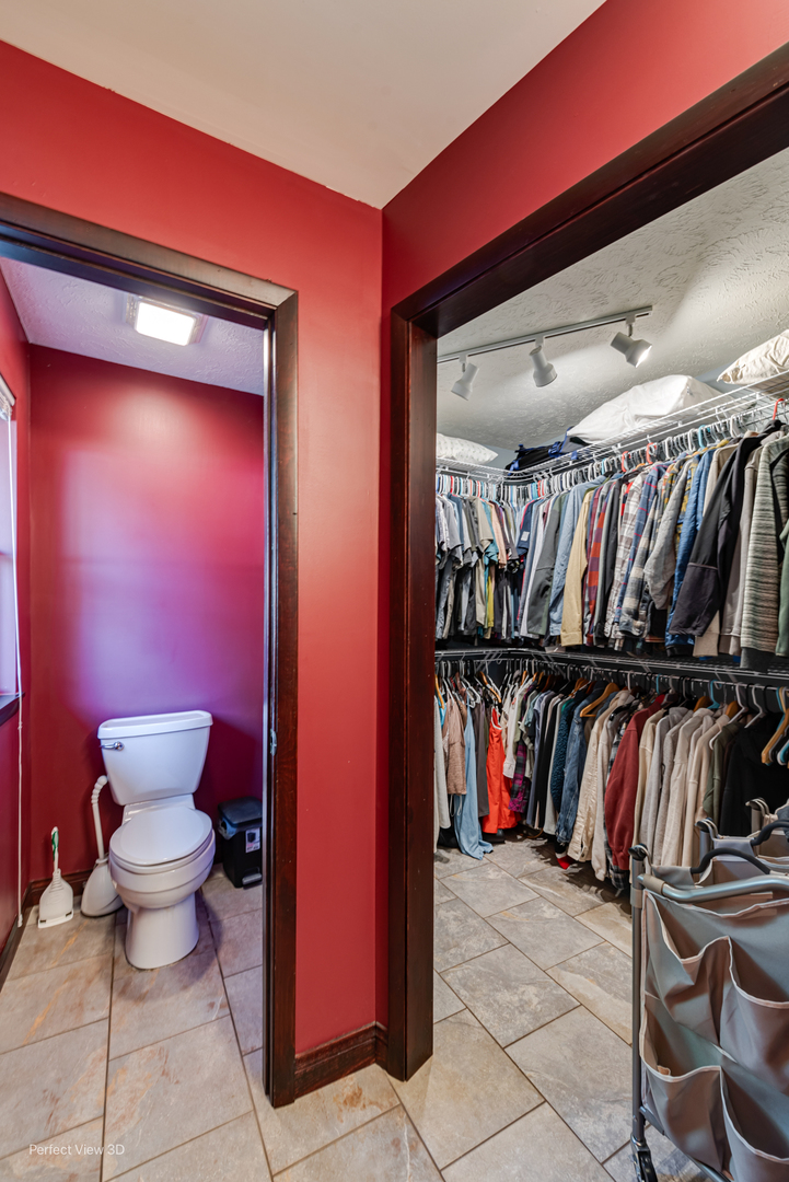 800 Charles Street Morris, IL 60450 - Photo 22 of 24 a view of walk in closet with clothes and shoes