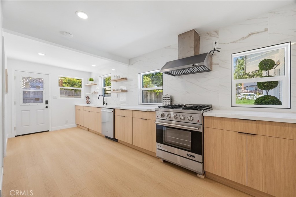 1280 East Woodbury Road Pasadena, CA 91104 - Photo 19 of 40 a kitchen with stainless steel appliances a stove and white cabinets