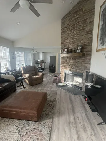 a living room with furniture and a fireplace
