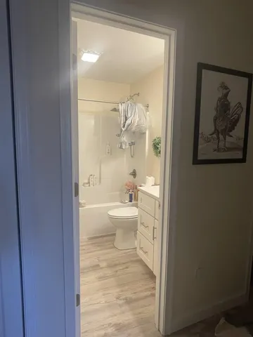 a bathroom with a toilet a sink and a large mirror