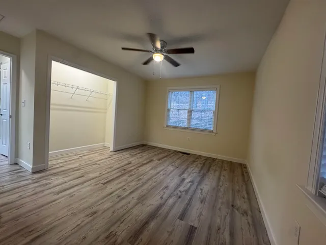 a view of a livingroom with a ceiling fan and window