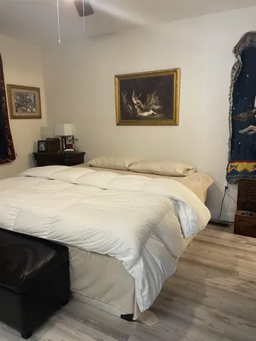a bedroom with a bed and a cabinets